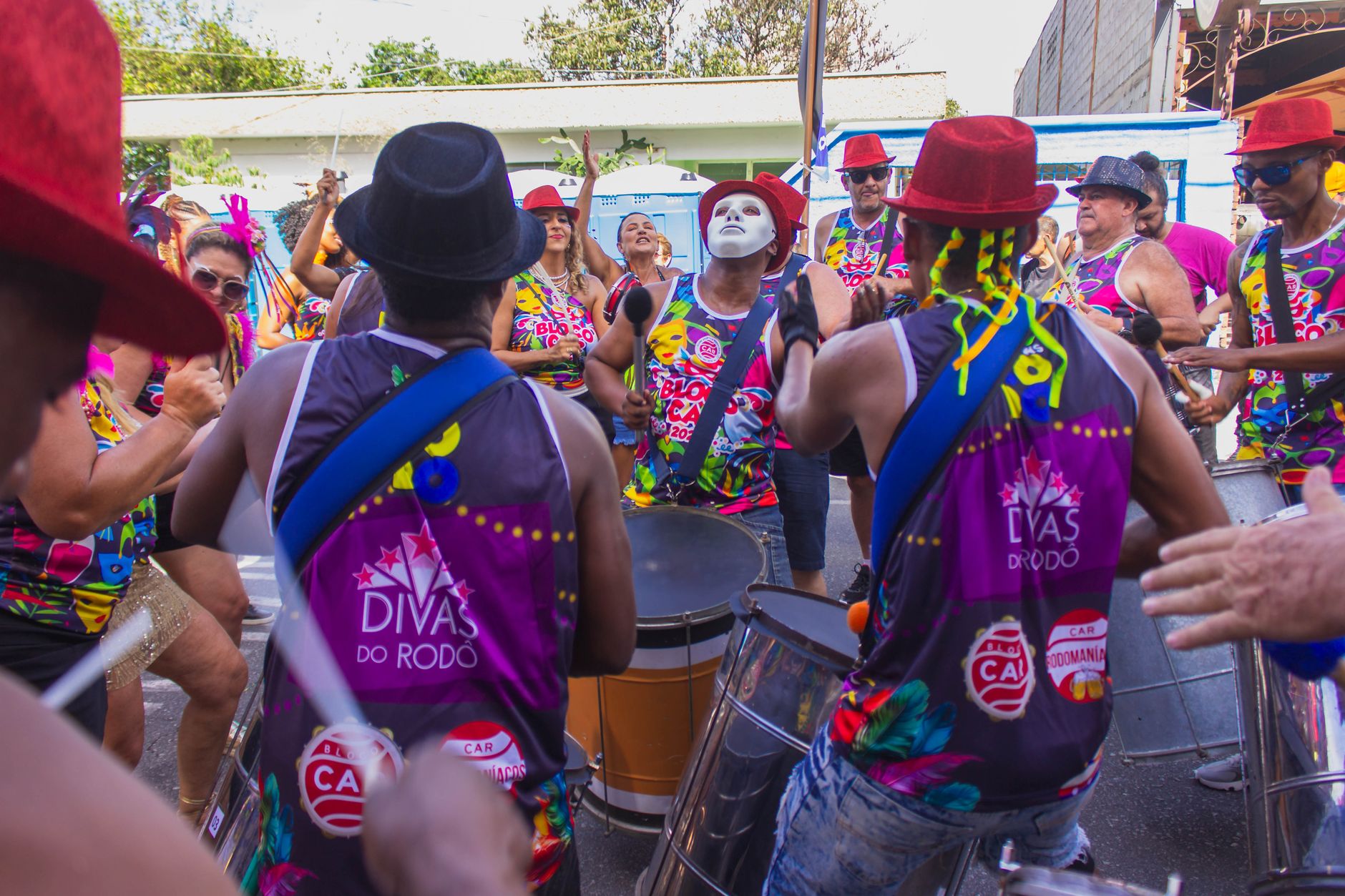Vibrant street performance during Carnival with drummers and colorful costumes.